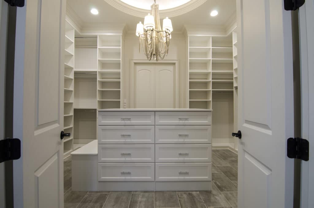 beautiful white dream closet with bright lighting