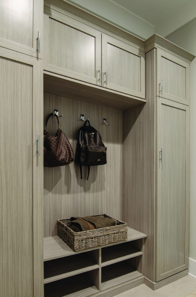 custom built mudroom with backpacks hanging on the hooks