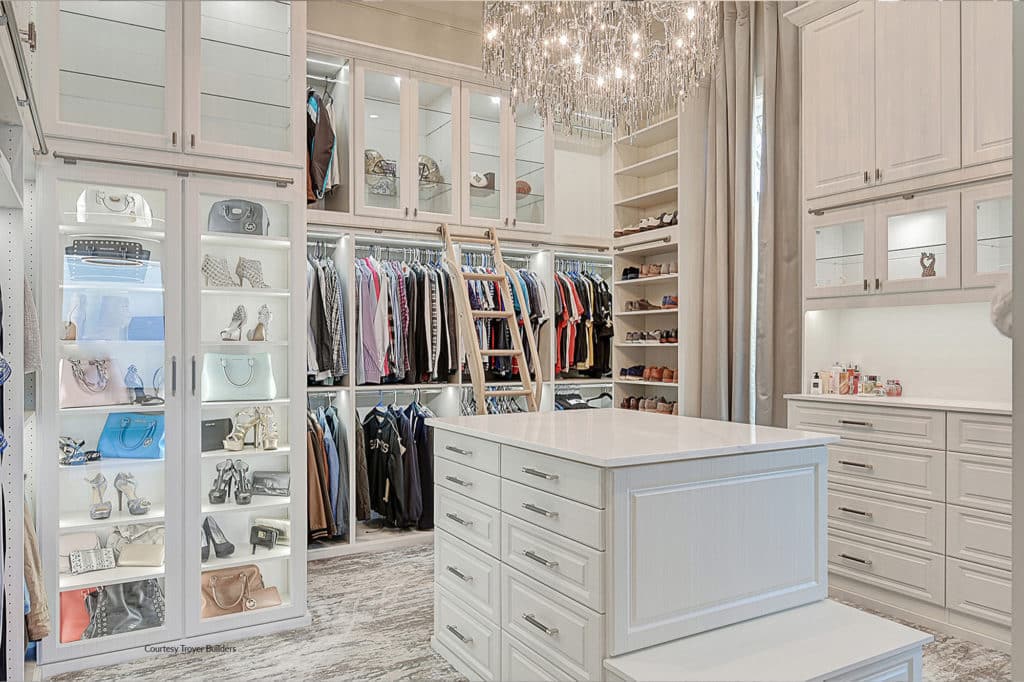 beautiful custom built master closet with bright lighting